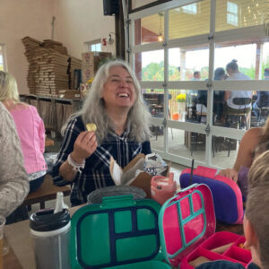 Gabrielle laughing while eating chips